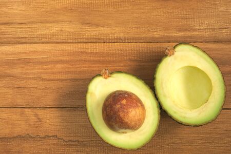 Cross section of Avocado on top of wooden table