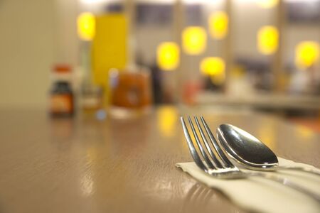 Abstract silverware on top of table with blurry restaurant backgroundの写真素材