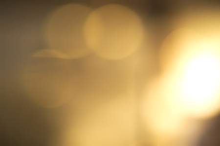 Abstract vivid yellow and white bokeh backgroundの写真素材
