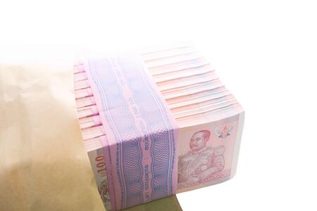 10 packs of 100 of new hundredth baht notes within brown envelope worth 100,000 baht over white...
