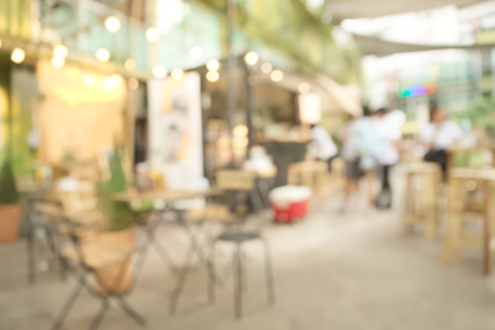 Abstract blurry bright restaurant interior with unrecognizable waitressの写真素材