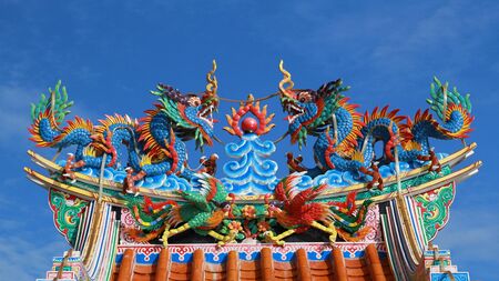 Statue of twin dragons on Chinese temple roofの写真素材