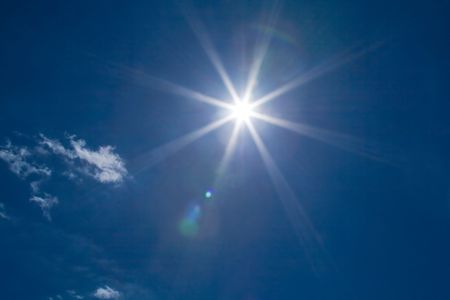 Sun on blue sky with clouds