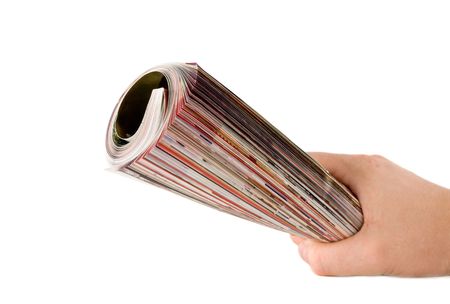 Roll of magazine in hand. Isolared on whiteの写真素材