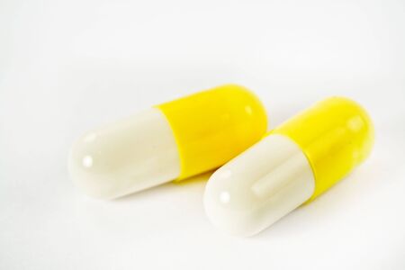 Two pills on white backgroundの写真素材