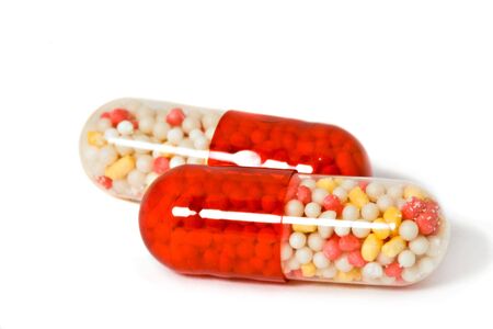 Two pills on white background