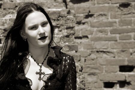 Young gothic girl and ruins of castle