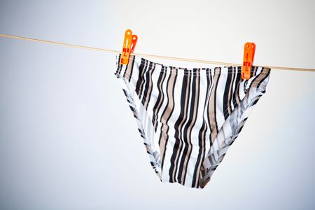 Striped briefs hanging on a clotheslineの写真素材