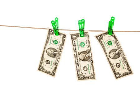Dollar bills pinned to a clothesline. Isolated on white background