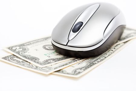 Computer mouse on dollars. Isolated on white backgroundの写真素材