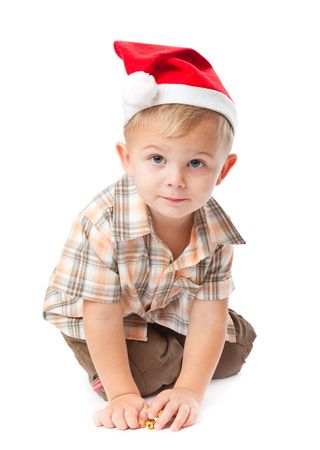 Little boy wearing a Santa hat. Isolated on white backgroundの写真素材
