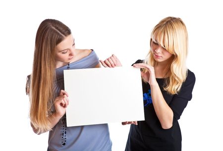 Two teenage girls with card for text.  Isolated on white backgroundの写真素材