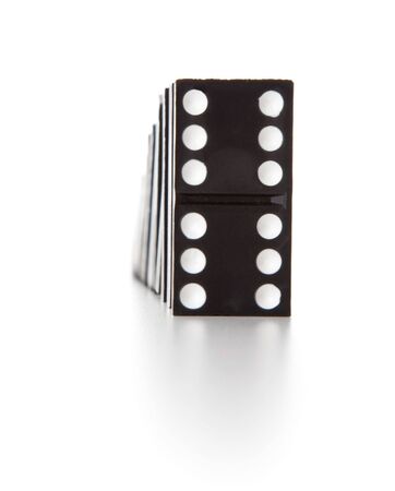 Stack of dominoes falling. Isolated on a white backgroundの写真素材
