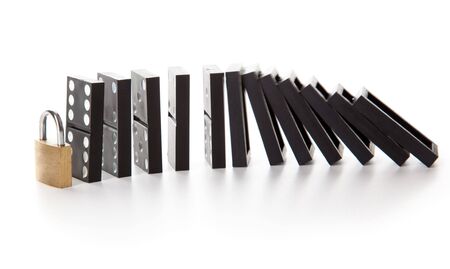 Stack of dominoes falling. Isolated on a white backgroundの写真素材