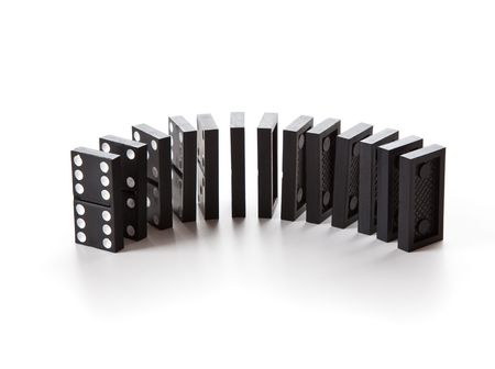 Stack of dominoes falling. Isolated on a white backgroundの写真素材