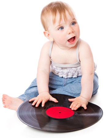 The small child with a black gramophone record. Isolated on white backgroundの写真素材