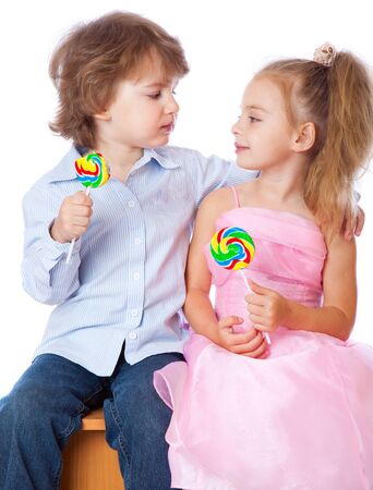 Boy and girl with lollipops. Isolated on white backgroundの写真素材