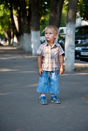 a contracted little boy lost in the streetの写真素材
