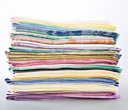 a stack of colored towels. isolated on a white backgroundの写真素材