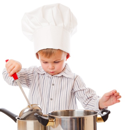 a funny cute boy is portraying a cook. isolated on a white backgroundの写真素材