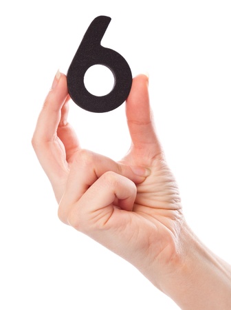 A number six in the hand. Isolated on a white backgroundの写真素材