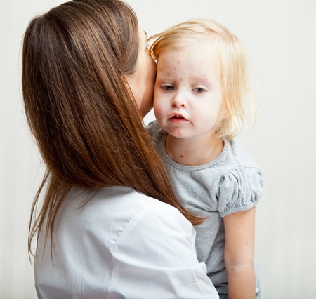 a mother is holding tight a sick girl. の写真素材