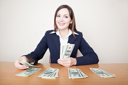 Young business woman with dollarsの写真素材
