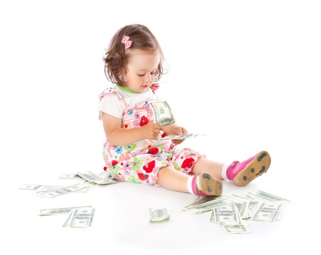 A little girl with money. Isolated on a white backgroundの写真素材