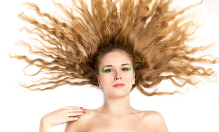 A beautiful young woman in a studio. Isolated on a white backgroundの写真素材