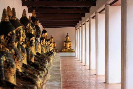 Row of old golden buddha statue at Wat Phra Boromathat Chaiya, Surat Thani province, south of Thailandの写真素材