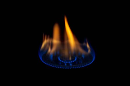 Gas burner flame at gas stove on dark background,selective focus