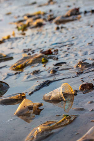 Garbage and waste plastic bags and other environment pollution on the beachの写真素材