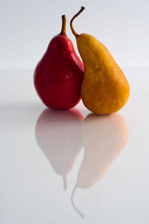 Two pears, along with their reflectionsの写真素材