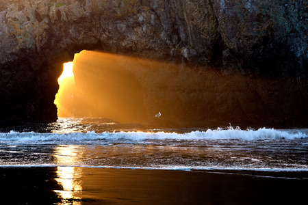 Sunset Light Through Coastal Rockの写真素材