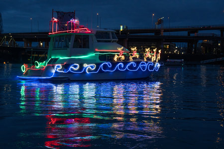 Boat with Christmas lights on the river at night in St. Petersburg.