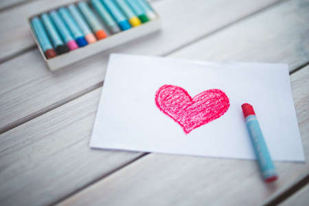 A picture of heart on a white paper in a tableの写真素材