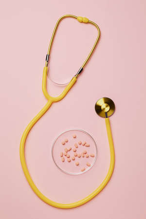 a stethoscope on a table with some capsuleの写真素材
