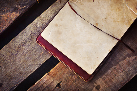 White papers in a copybook on the wooden deskの写真素材