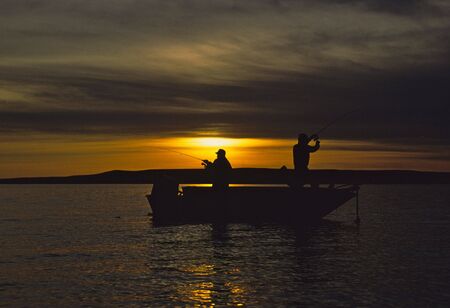 Two Fisherman in Boat in Sunsetの写真素材