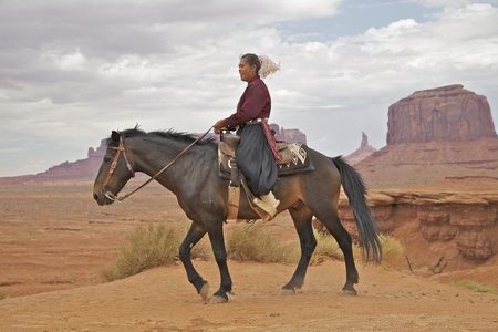 Navajo Woman on Horse in Monument Valleyの写真素材