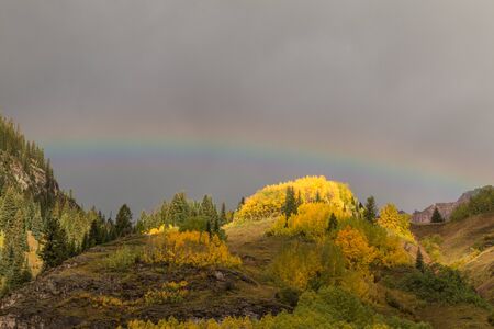 Rainbow Over Mountains in Fallの写真素材