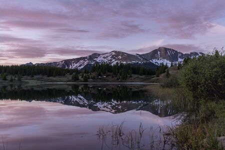 Scenic Sunrise Reflection in a Mountain Lakeの写真素材