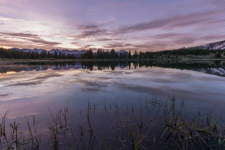 Scenic Sunrise Reflection in a Mountain Lakeの写真素材