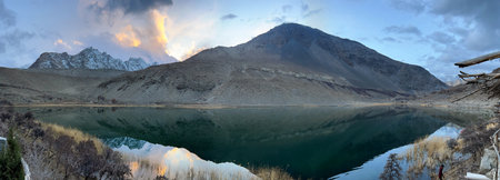 Panoramic view of a mountain lake in the winter at sunsetの写真素材