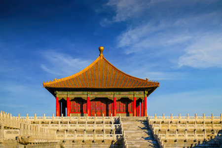 Closeup view of the Hall of Zhonghe in Beijing's Forbidden City under clear blue sky, showing classic symmetry and imperial architecture beauty.の写真素材