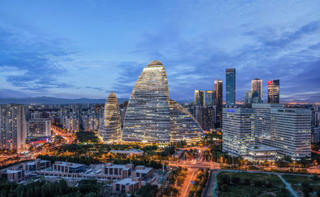 Iconic Wangjing SOHO towers lit up at twilight, showcasing Beijing's modern urban landscape and innovative architectural design.の写真素材