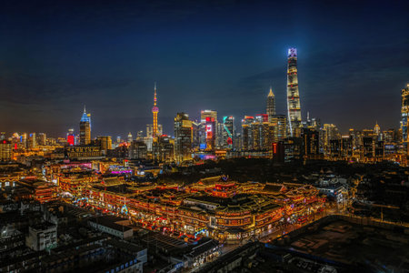 Aerial night view of Yuyuan Garden and Lujiazui skyline with Shanghai Tower and Oriental Pearl in...