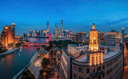 A panoramic view of the Shanghai Lujiazui skyline at blue hour, featuring illuminated skyscrapers...
