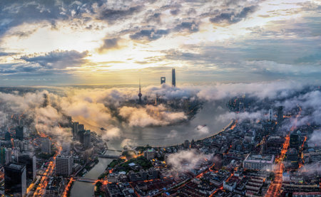 A stunning aerial shot of Shanghai's Pudong skyline at sunrise, featuring the Shanghai Tower and...