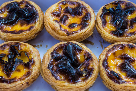 Egg tart in a paper box.